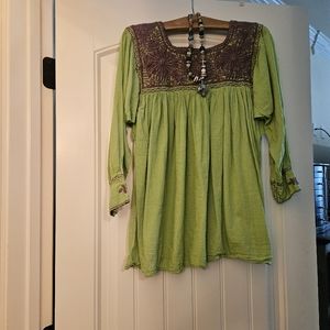 Lime green blouse with purple embroidery.